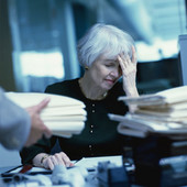 Woman at work looking overloaded
