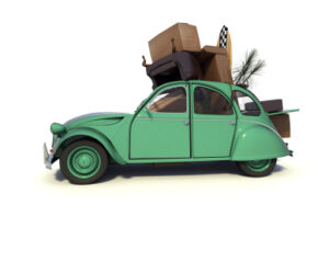 Car over packed with furniture to depict moving