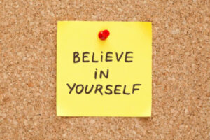 Believe in yourself - post it note pinned onto cork board