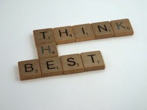 Small wooden letter tiles spelling out the words Think The Best