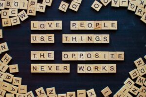 Scrabble pieces forming the message, Love People Use Things, The Opposite Never Works
