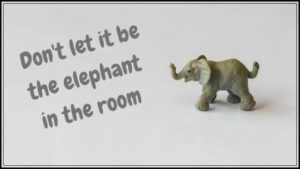 A model elephant with the words "Don't let it be the elephant in the room"