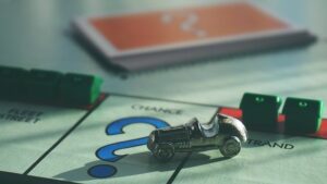 Help your team thrive, car playing piece landing on chance on a Monopoly game board