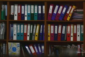 Photo of a colourful assortment of labelled files on shelves for resources for wellbeing at work newsletter